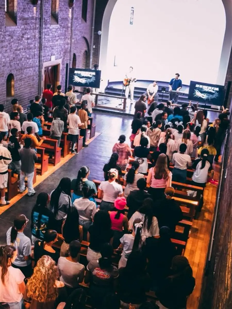 Students filling the chapel pews for a worship service