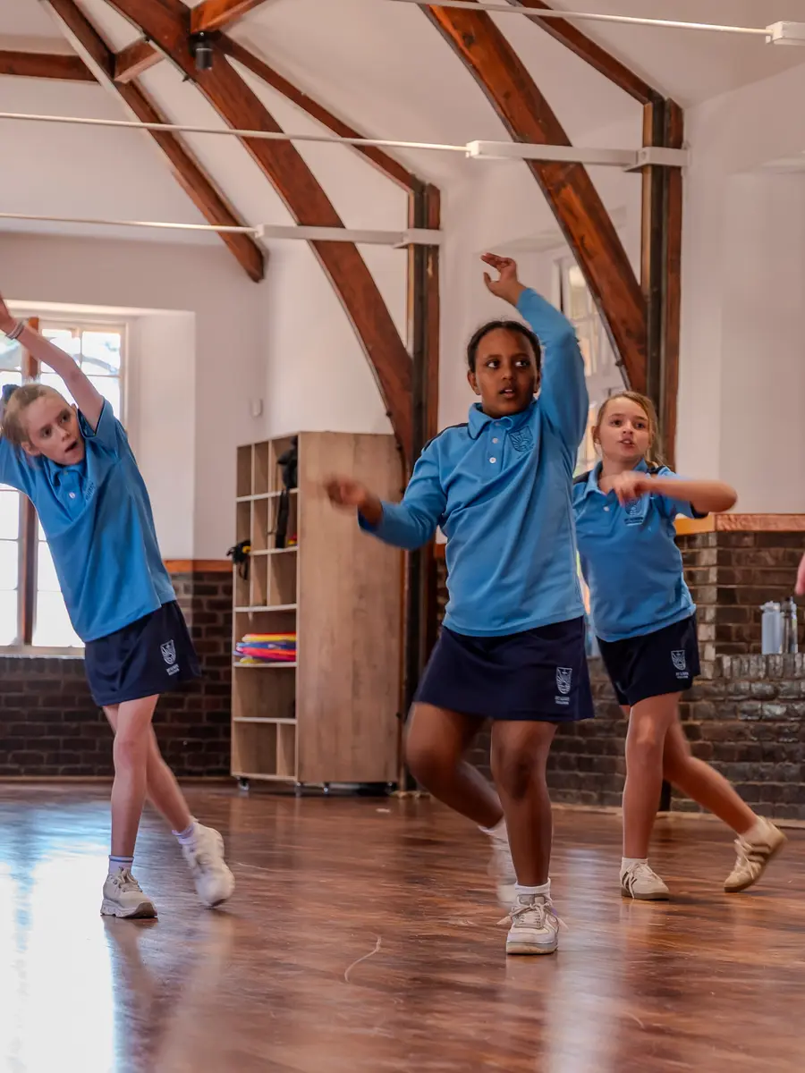Children stretching in a dance class with their teacher