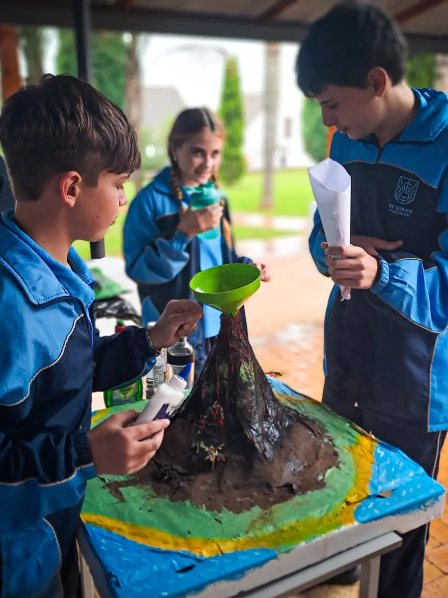 Grade 7 boys testing the volcano they built for science