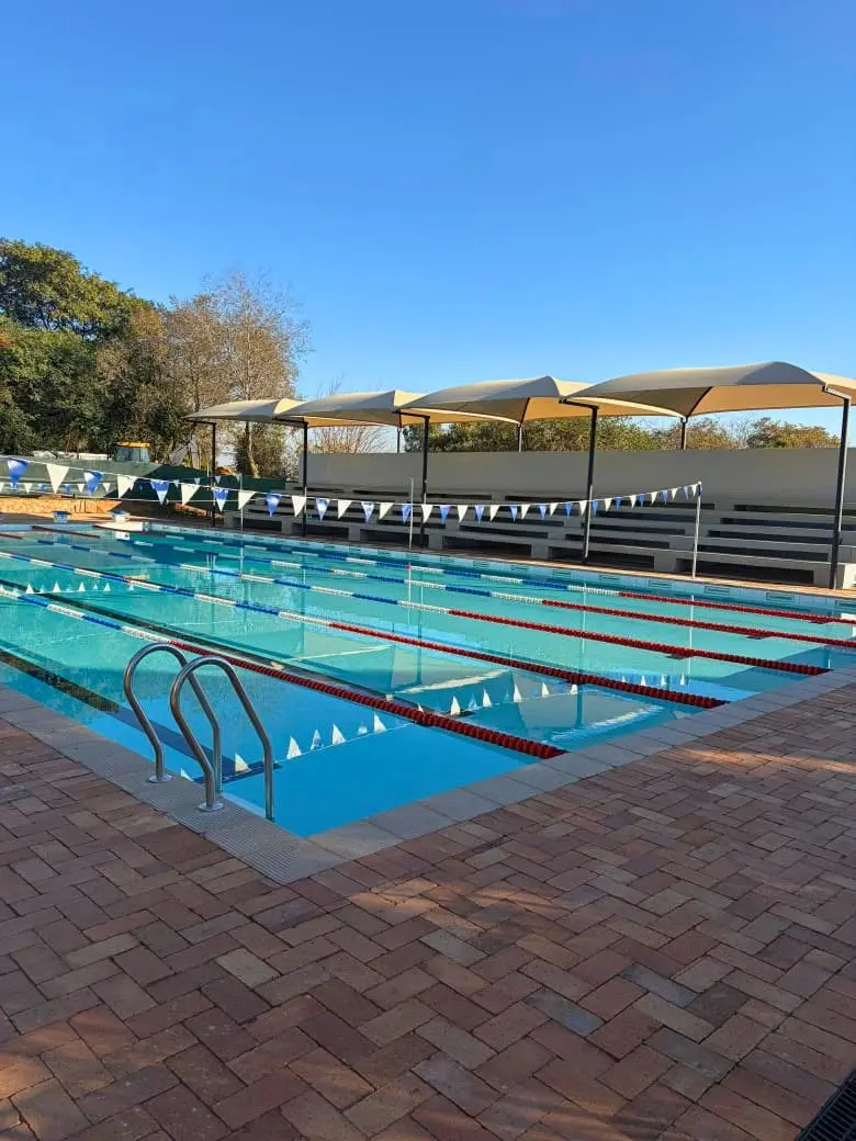 The swimming pool with shaded spectator stands