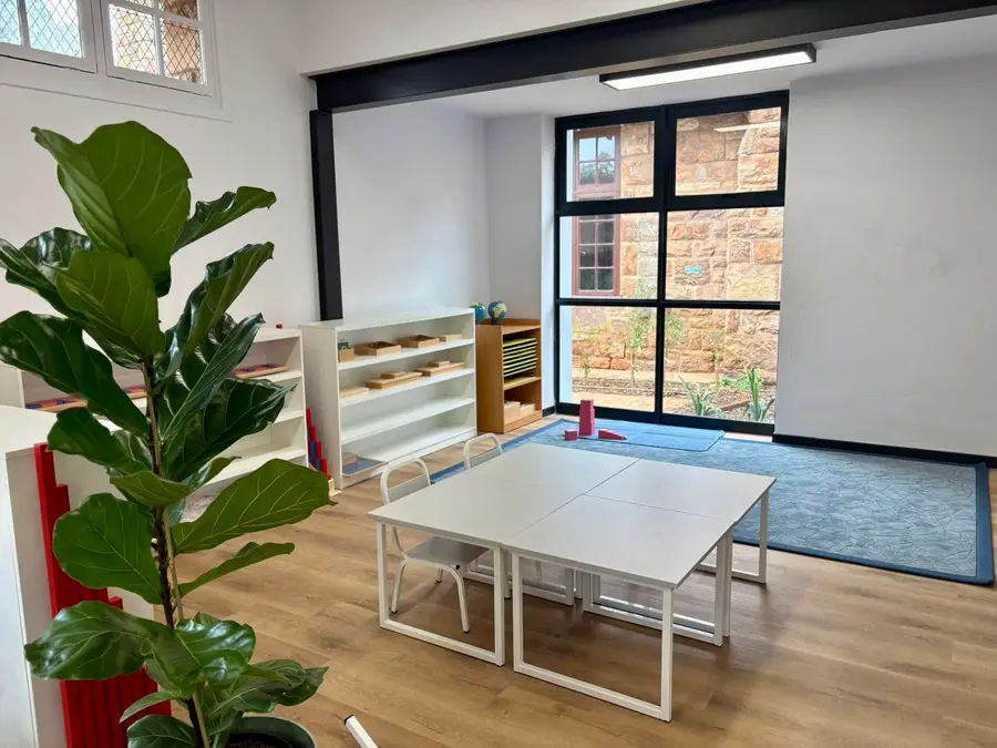 A light-filled Preschool classroom with low shelves and child-sized tables