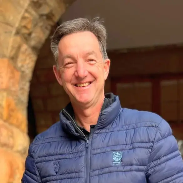 Michael Schwartz, Executive Head of St Luke's College, smiling in a St Luke's jacket